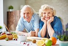 Man and woman smiling while in the kitchen